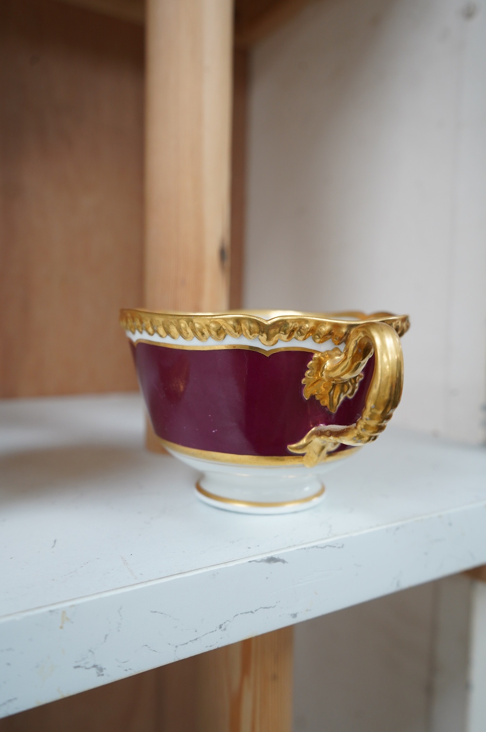 An armorial mug with lithophane figural scene to the base, together with a similar cup, largest 12cm high. Condition - mug poor, cup is good